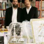 Rabbi Eliyahu Shear and Orphan Chatan Receiving Gifts from Chessed Ve'Emet