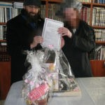 Rabbi Eliyahu Shear and Orphan Chatan Receiving Gifts from Chessed Ve'Emet