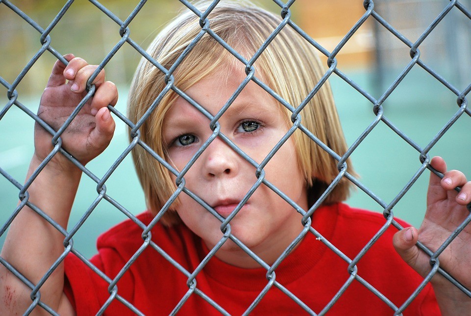 Boy Behind Fence